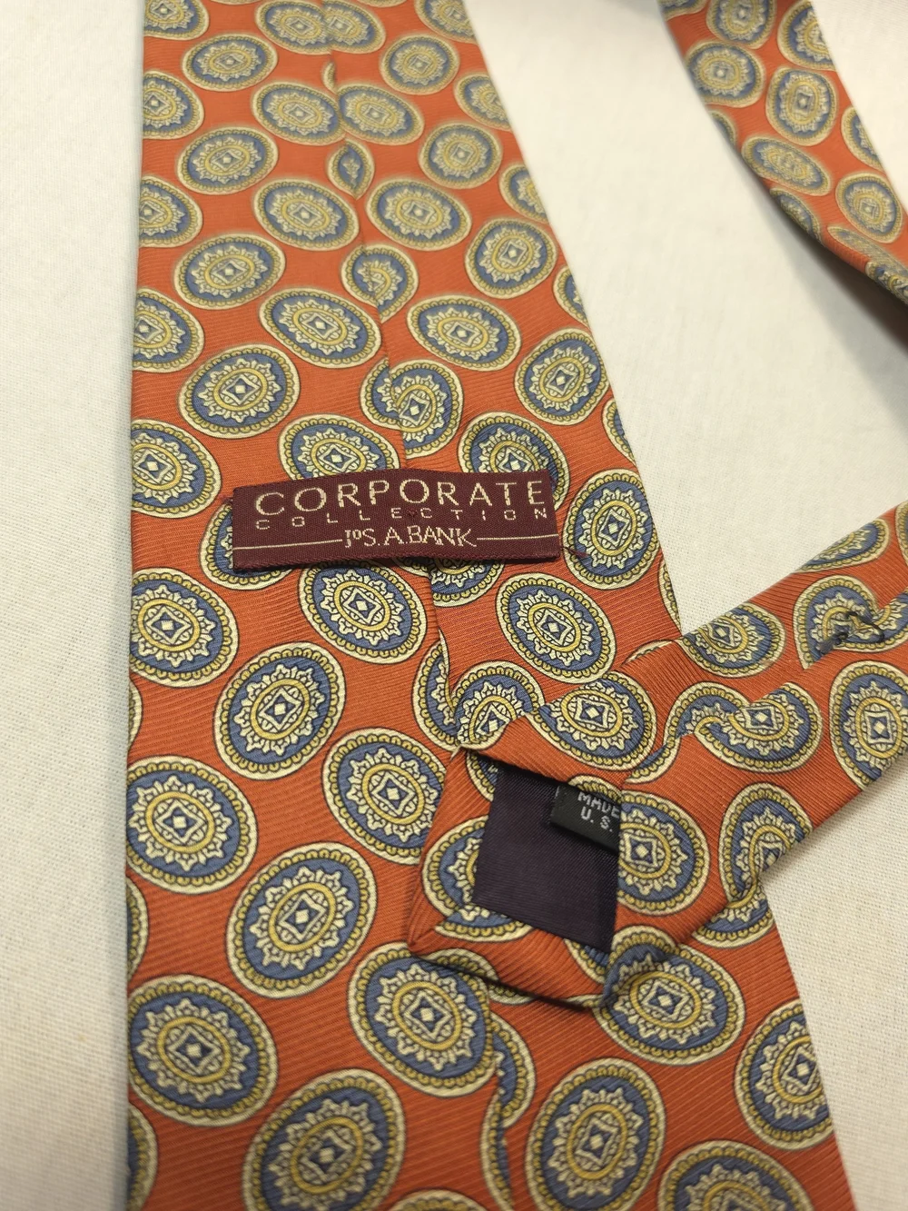Jos. A. Bank Orange Tie with Blue and Gold Medallions